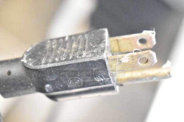 Close-up of a plug for the Waring 32DM16 Commercial Drink Mixer. The black plug shows slight wear. 120V, 1 phase.