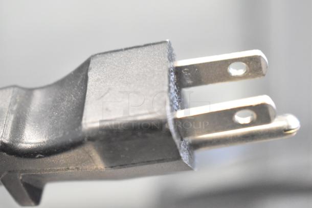 Close-up of a two-prong plug for 2 Server FSP commercial countertop topping warmers, 120 volts, 1 phase.