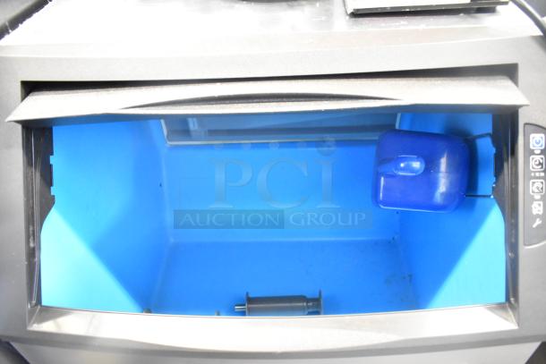 Manitowoc UYF0140A-161B undercounter ice machine interior showing half dice cube storage area. Model, 115V, 1 Phase.