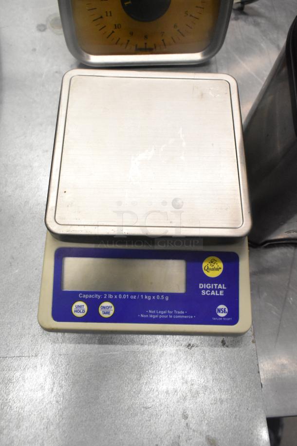 Qualite digital scale with stainless platform, capacity 2lb/1kg, features include unit hold and tare functions.