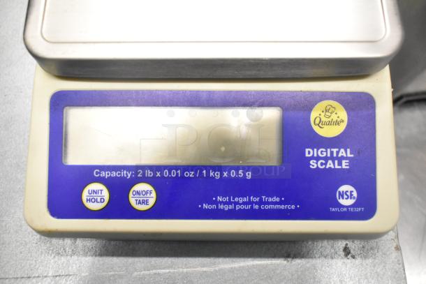 Qualite digital scale with a 2 lb capacity, clear display, and buttons for unit hold and tare. Model: Taylor TE32FT.