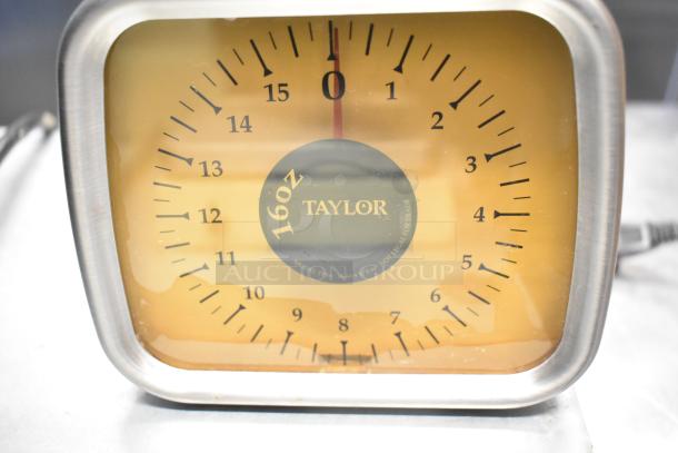 Taylor analog scale with 16oz capacity, model TP16, in good condition. Brown face, clear markings.