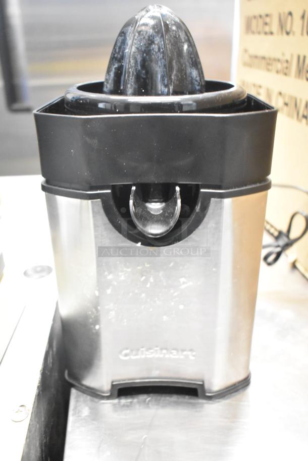 Cuisinart juicer base, stainless steel with black accents, used condition, brand logo visible on the front.