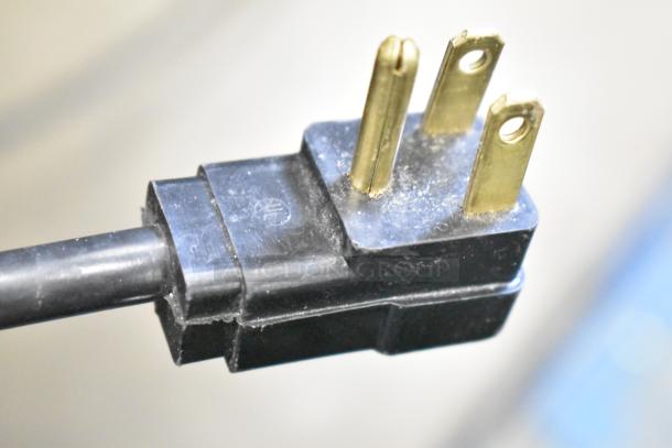 Close-up of a three-prong electrical plug for the Beverage Air BB72HC-1-GS-B commercial cooler, showing a standard 115-volt connection.