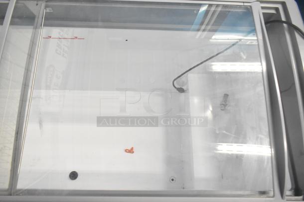 SD-575 commercial novelty ice cream freezer merchandiser, 115 volts, 1 phase, showing transparent top and power cord, used condition.