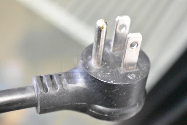 Close-up of a 3-prong plug for the 2024 True GDM-35-HC cooler. The plug is standard for 115 volts, 1 phase operation.