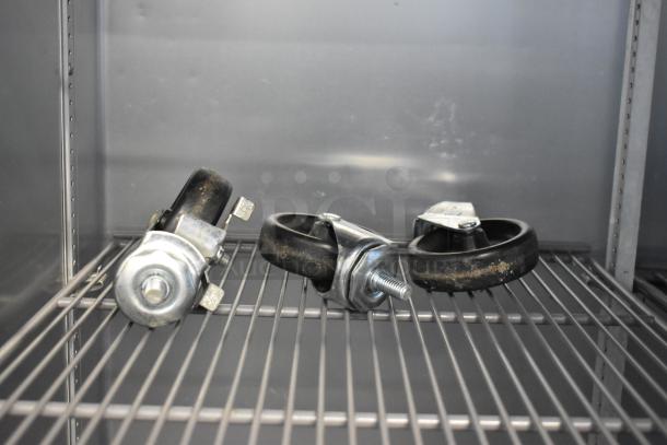 2021 True T-35-HC commercial reach-in cooler interior showing shelves and caster wheels. 115 volts, 1 phase.