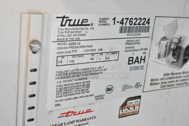 True GDM-12-HC-LD cooler label with model, serial number, voltage, refrigerant type, and warranty details.
