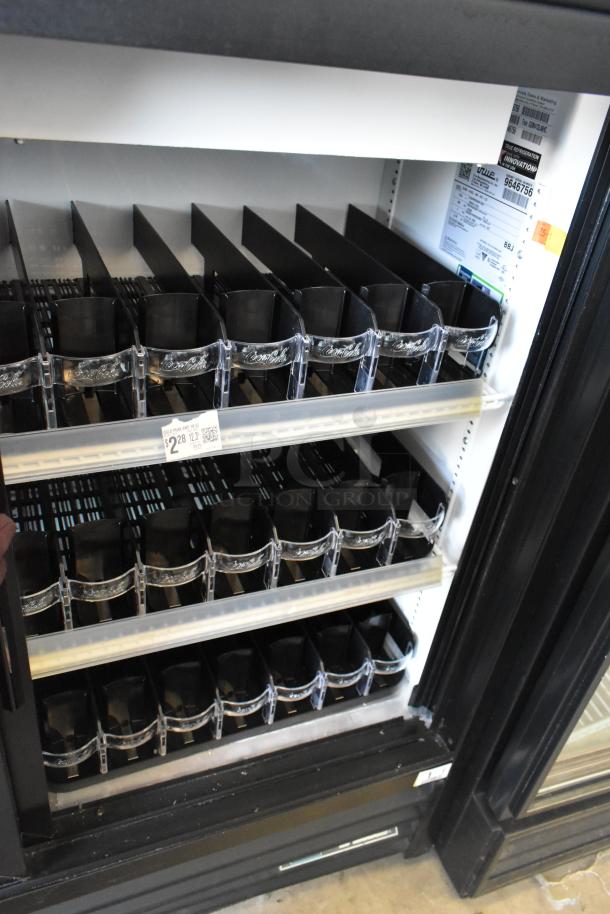 2019 True GDM-41SL-48-HC-LD 2-door cooler merchandiser with shelves, Coca-Cola branding, and store price tags visible.