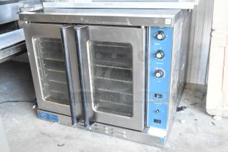 Duke commercial full-size convection oven with view-through doors, thermostatic controls, and blue panel. Used condition.