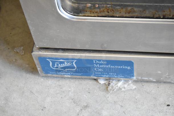Duke Commercial Full Size Convection Oven with view-through doors, thermostatic controls, and Duke branding. Visible wear.