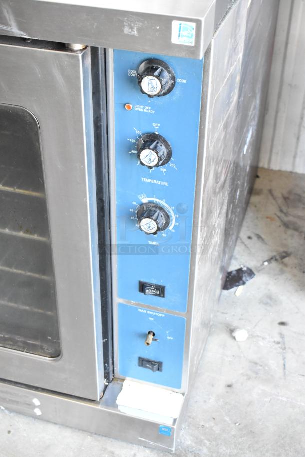 Duke full-size convection oven with view-through doors, thermostatic controls, and timer. Moderate wear, gas shutoff visible.