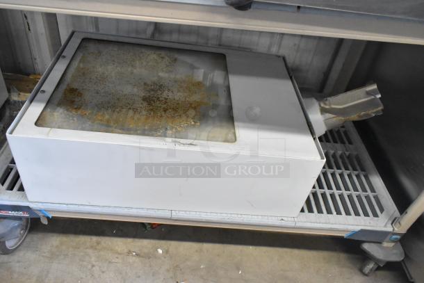 Metal lighting fixture, rectangular, with rust on glass panel. Used condition, stored on metal shelf. No visible brand.