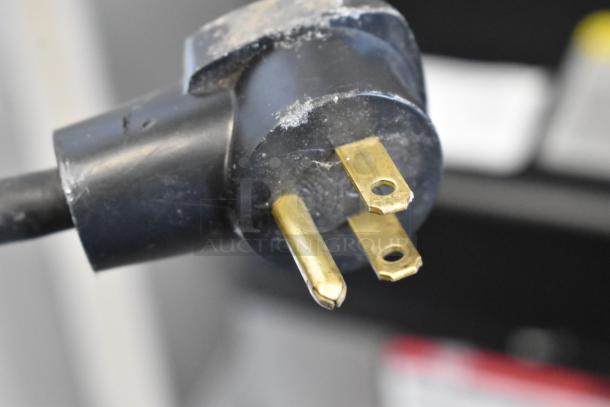 Close-up of a plug compatible with the 2023 Nemco 6625B Commercial Steamer, showing three-prong electrical connection.