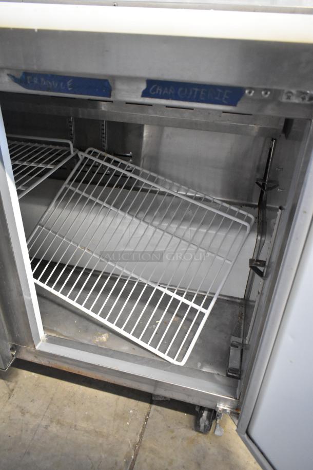 Avantco 178APT71HC Mega Top Sandwich Salad Prep Table with open stainless interior, shelves, visible labeling, on casters.