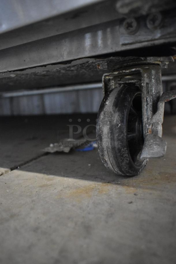 Avantco 178APT71HC prep table caster, showing wear. Features commercial strength, 115V, 1 phase power.