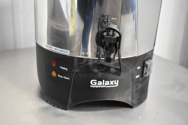 Stainless steel Galaxy 177GCU100 coffee urn, 100-cup capacity, heating indicators, hot surface caution, 120V, new condition.
