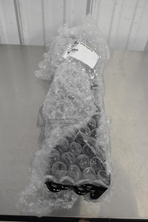 Brand new TR36 Ticket Rack in bubble wrap; includes Delfield 3516298 Evaporator Coil for 44 and D44 series. OEM label visible.