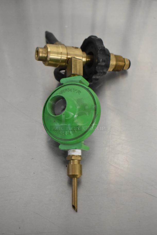 Brass and green connector labeled "Zephyr," brand new with minor scratches and dents, includes handle and two connectors.