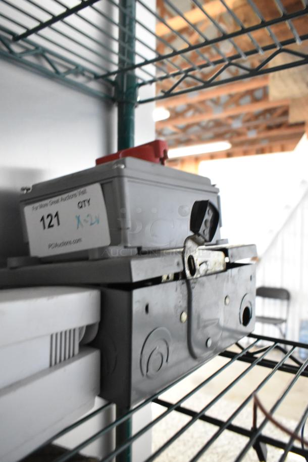 Eaton and Square D control boxes on a shelf, labeled "121 QTY 1-2." Slight wear visible.