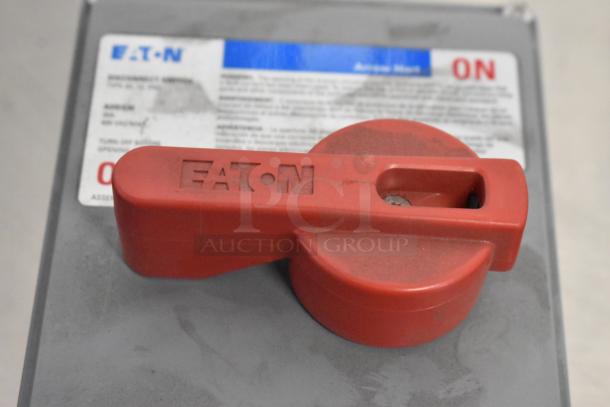 Eaton control box with red switch, labeled "ON." Visible Eaton branding on switch lever.
