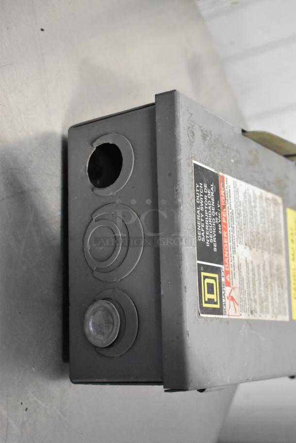 Square D control box, metal case, visible labels, good condition, features knockouts for wiring. Includes branding details.