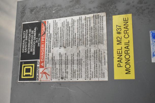 Square D control box with safety switch, warning label, and yellow "Panel M2 #37 Monorail Crane" marking.