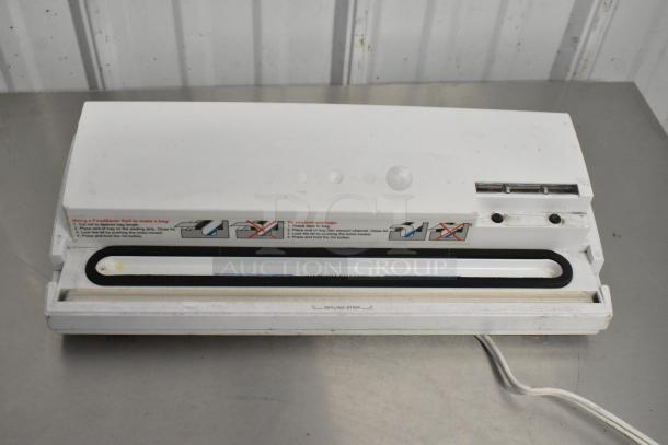 Food Saver Vac750 vacuum bag sealer with visible instructions, slight wear, and power cord on metal surface.