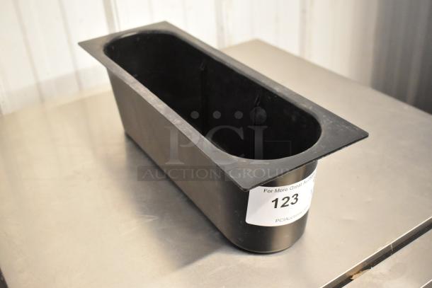 Black poly bin on metal surface, rectangular shape, used condition, auction label "123," part of a two-item set with a metal pan.