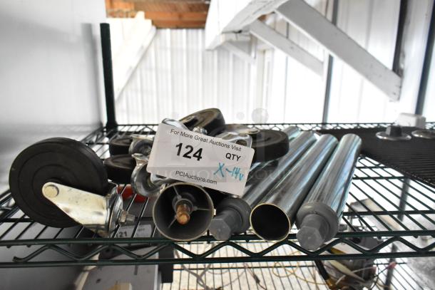 14 items including metal legs and commercial casters on a metal shelf; auction label shows lot number 124, quantity X-14.