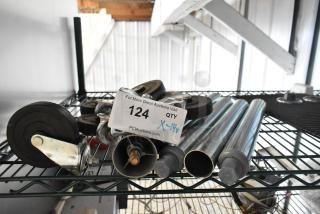 14 items including metal legs and commercial casters on a metal shelf; auction label shows lot number 124, quantity X-14.