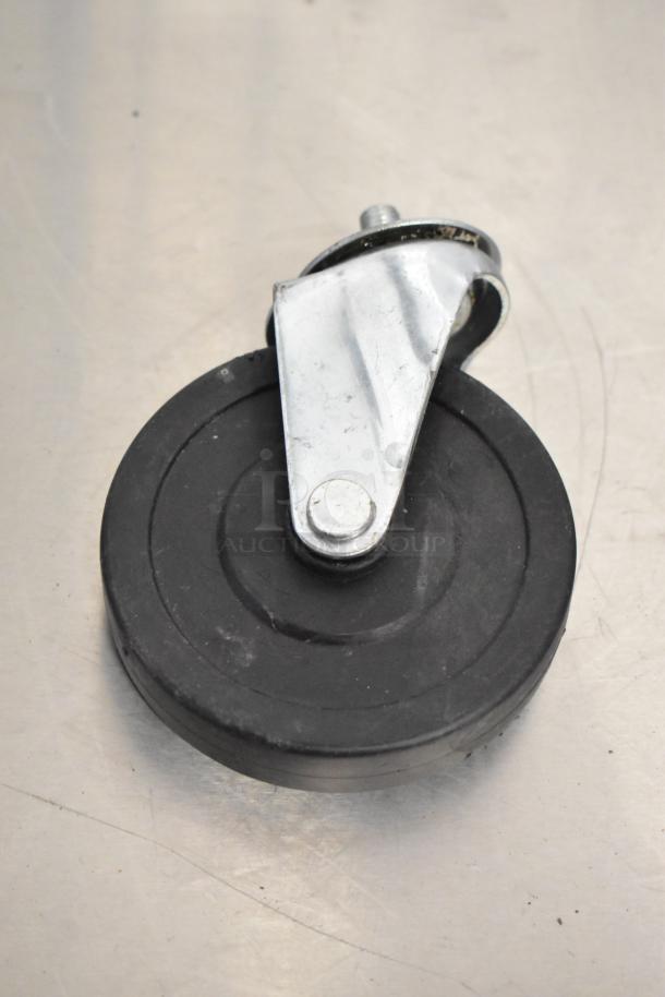 Metal caster wheel with black rubber rim and silver bracket, part of auction lot including 14 items like metal legs and casters.