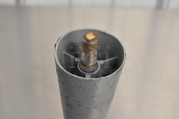 Close-up of a metal leg with visible rust on threaded end, part of a lot of 14 items including commercial casters.
