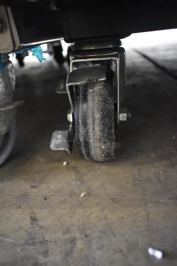 True T-23F-HC commercial freezer caster showing moderate wear, suitable for mobility on concrete floors.