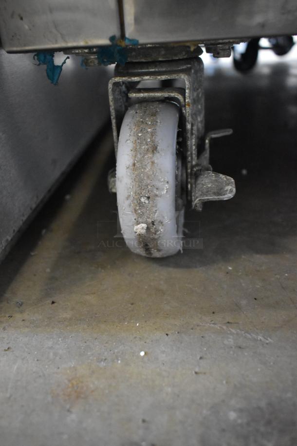 Dukers D28AF commercial freezer caster, showing wear and residue. Single door, 115V, 1 phase, on commercial casters.