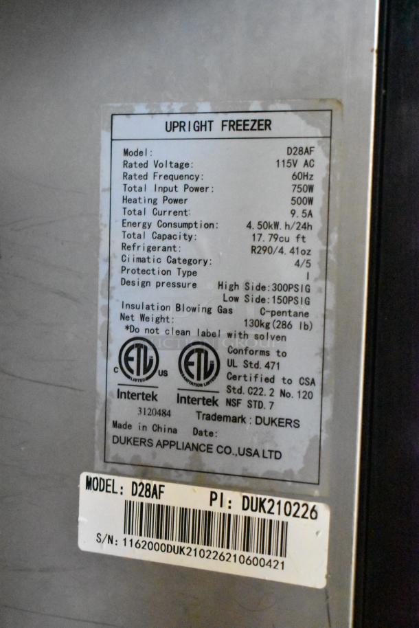 Dukers D28AF commercial freezer label details; 115V, 1 Phase, 17.79 cu ft capacity, R290 refrigerant, on casters, model and serial number visible.