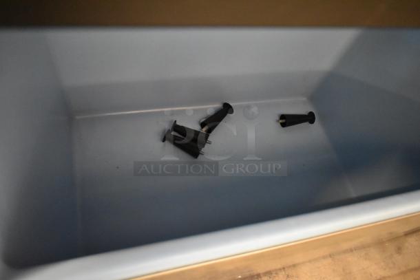 Empty Ice-O-Matic B110PS ice bin interior with black rubber components inside. Clean condition.