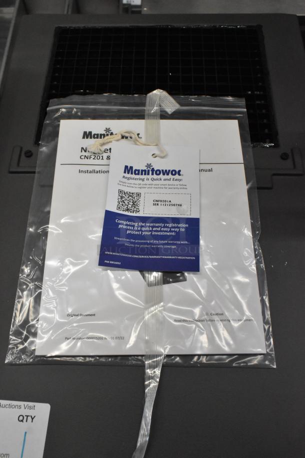 Brand new 2025 Manitowoc CNF0201A countertop nugget ice maker with documents and warranty info shown, model CNF0201A-161.