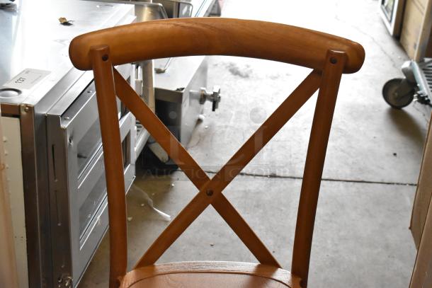 Three wooden dining height chairs, featuring a cross-back design and natural finish. Appears in good condition.