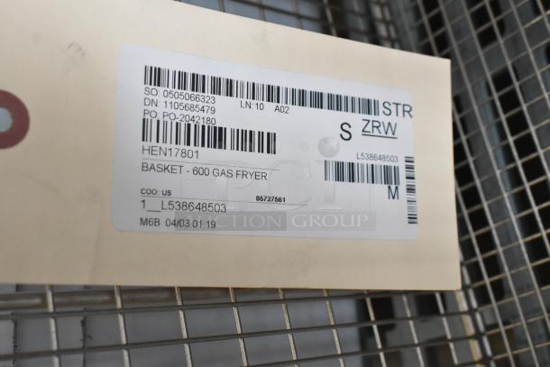Label showing model HEN17801, Basket - 600 Gas Fryer. New item tag with barcodes and reference numbers.