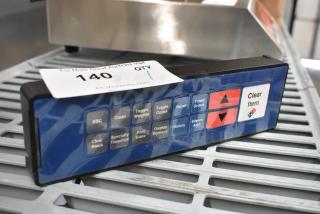 Control panel with multiple buttons including "ESC," "Clean," and "Clear Item." Features auction label with number 140.