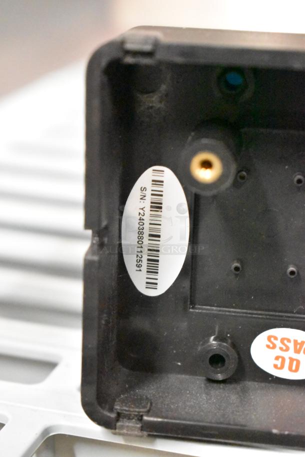 Black control panel casing with visible serial number "Y2403880112591" and inspection tag reading "QC PASS."