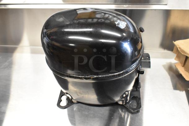 Brand new Embraco NEX4170UA compressor, 115-127V, with visible scratch and dent. Model 17831048, 1 Phase.