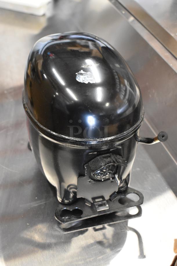 Brand new Embraco NEX4170UA compressor with minor scratches, 115-127 volts, 1 phase. Model number 17831048.