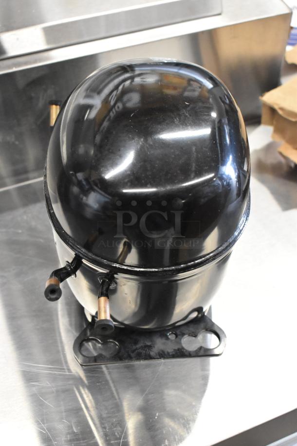 BRAND NEW SCRATCH AND DENT Embraco NEX4170UA Compressor, 115-127V, 1 Phase, slight surface marks visible.