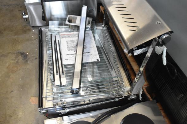 Brand new Bunn MHG heated display case, model 423HDM26SA. Features 3 shelves, sliding door, missing glass. 120V, 1 Phase.