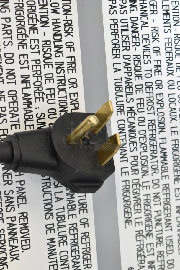 Close-up of a power plug for the Avantco 177CER400 4-burner electric range, showing warning labels. 208/240V, 1 Phase.