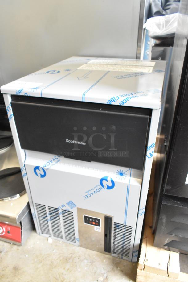BRAND NEW Scotsman UC0918GAX-1A undercounter ice machine, 95 lb. capacity, 115V, scratch and dent condition, protective cover.