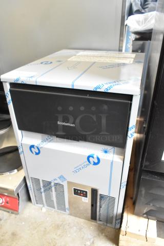 BRAND NEW Scotsman UC0918GAX-1A undercounter ice machine, 95 lb. capacity, 115V, scratch and dent condition, protective cover.