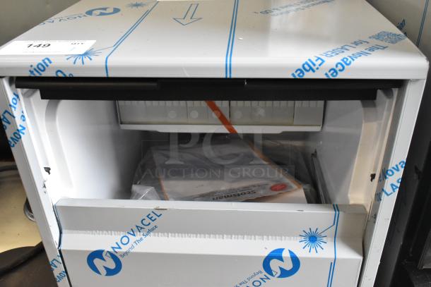 BRAND NEW SCRATCH AND DENT! 2025 Scotsman UC0918GAX-1A Undercounter Ice Machine, 95 lb. capacity, 115V, with protective wrapping, visible label.